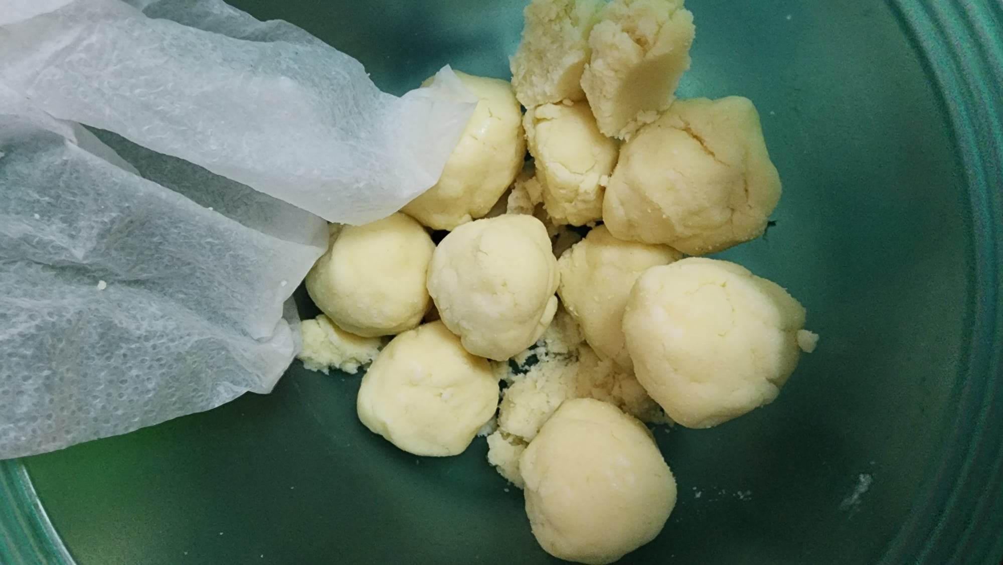 Corn tortilla dough divided into gold ball sized portions 