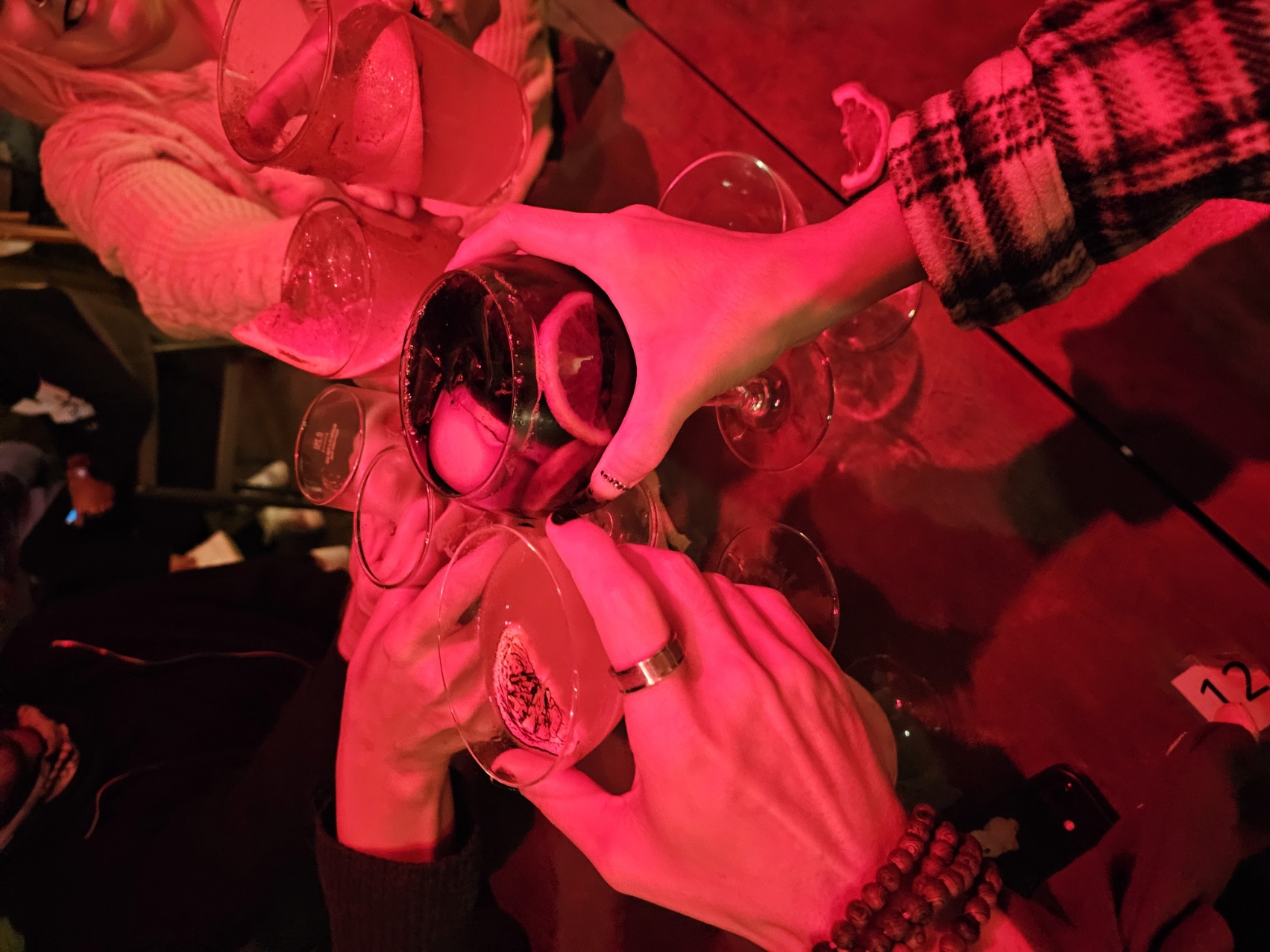 Friends clinking Halloween themed drinks under red lighting at Ofelia restaurant in Tavira Portugal