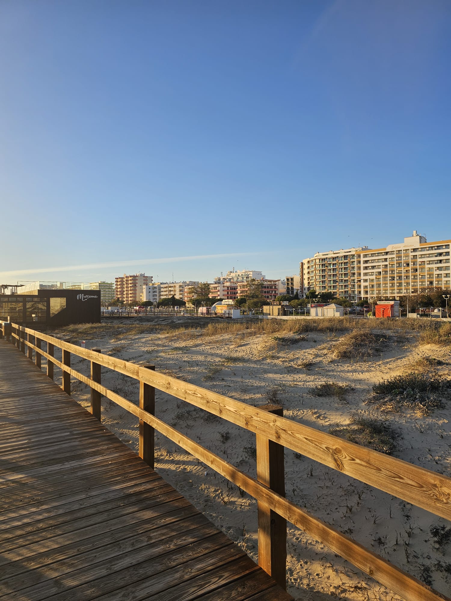 Monte Gordo beachfront with apartment buildings visible behind sand dunes in the Eastern Algarve Portugal