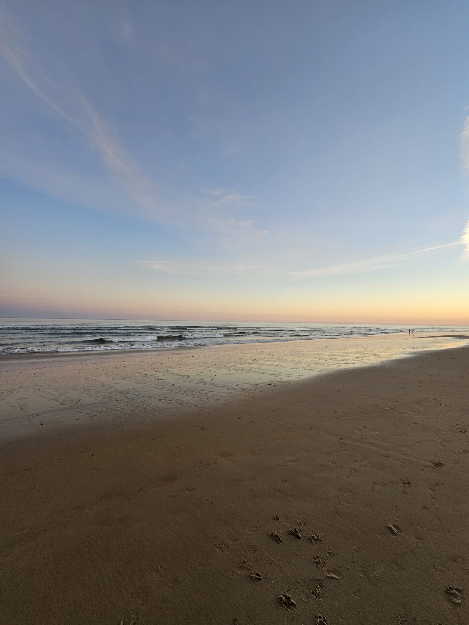 Quiet sunset beach at Manta Rota in the Eastern Algarve Portugal with golden light reflecting off wet sand