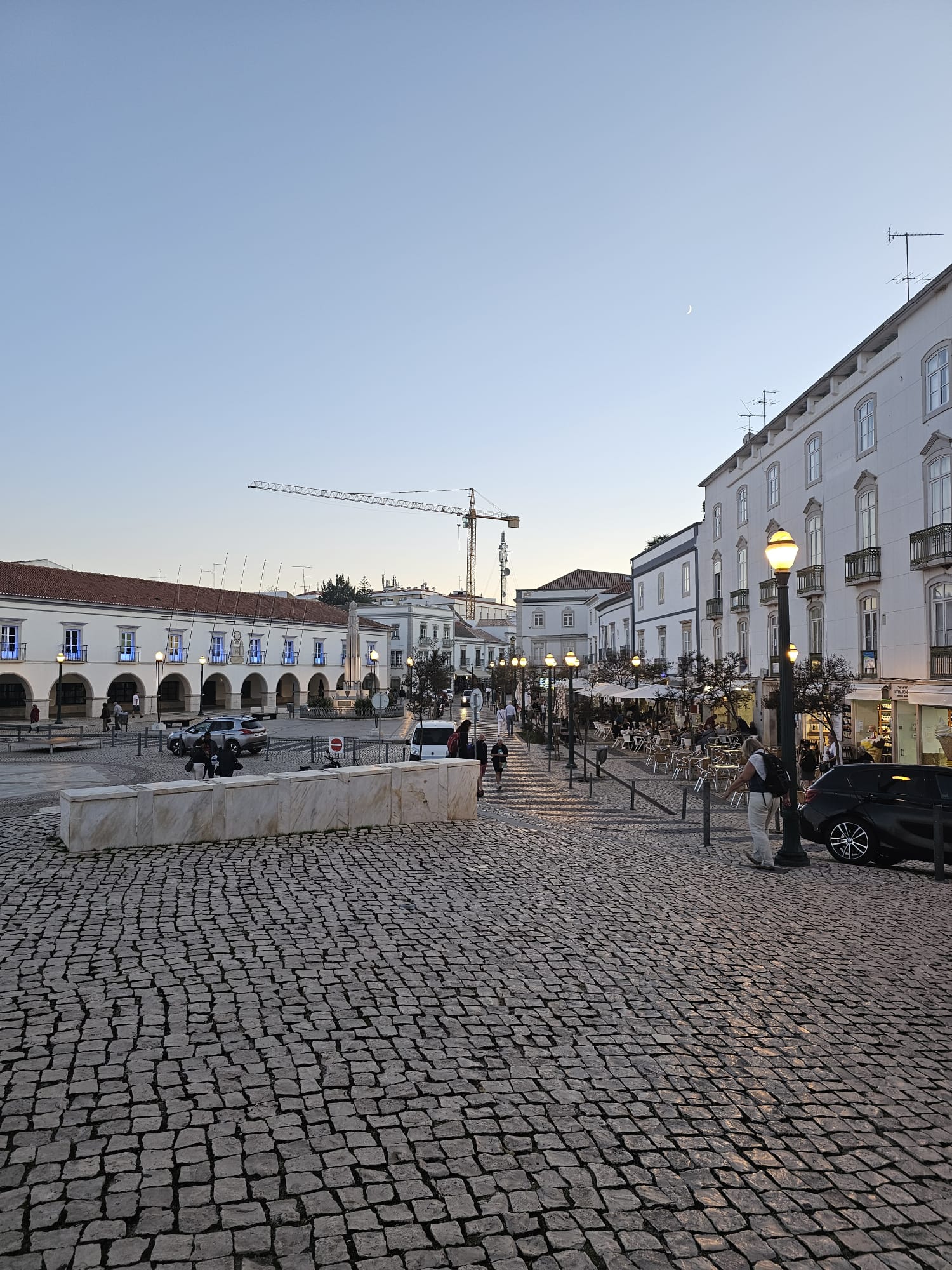 Tavira town center square with whitewashed buildings and outdoor cafe seating in November Portugal