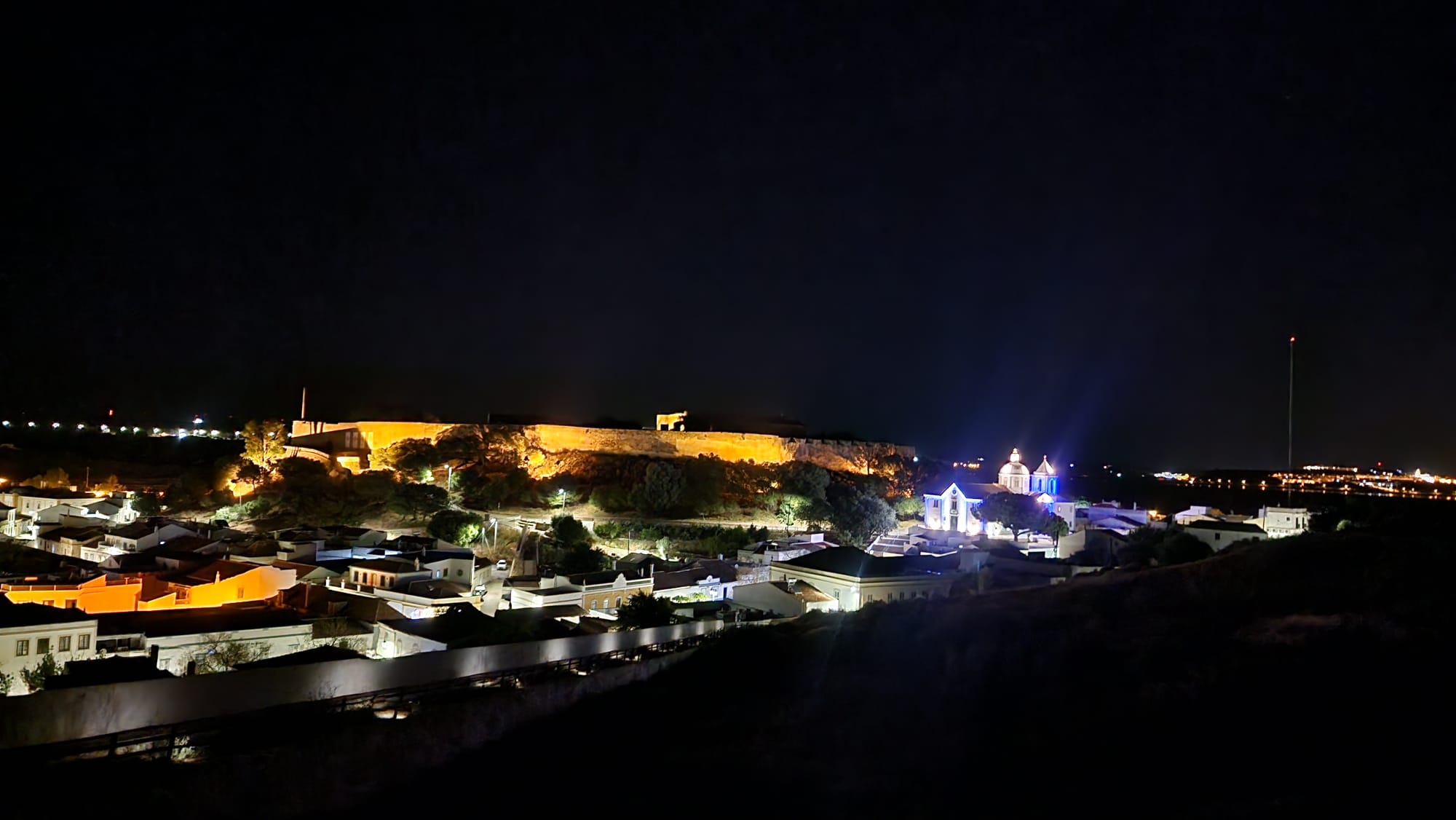 Night view of Castro Marim castle and village illuminated against the dark sky in the Algarve Portugal