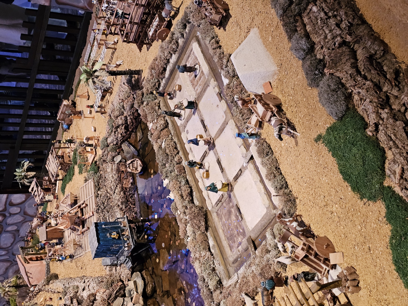 Miniature harbor and waterfront scene with figures in the VRSA nativity display