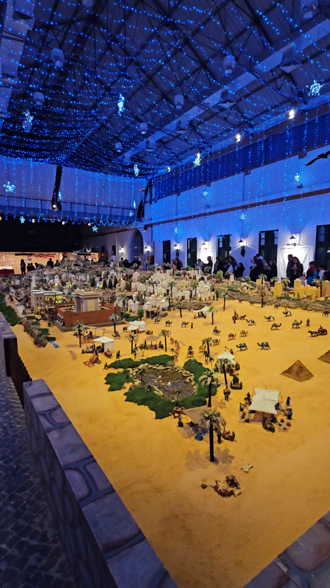 Wide angle view of the Egyptian themed section of Portugal's largest nativity scene under blue ceiling lights