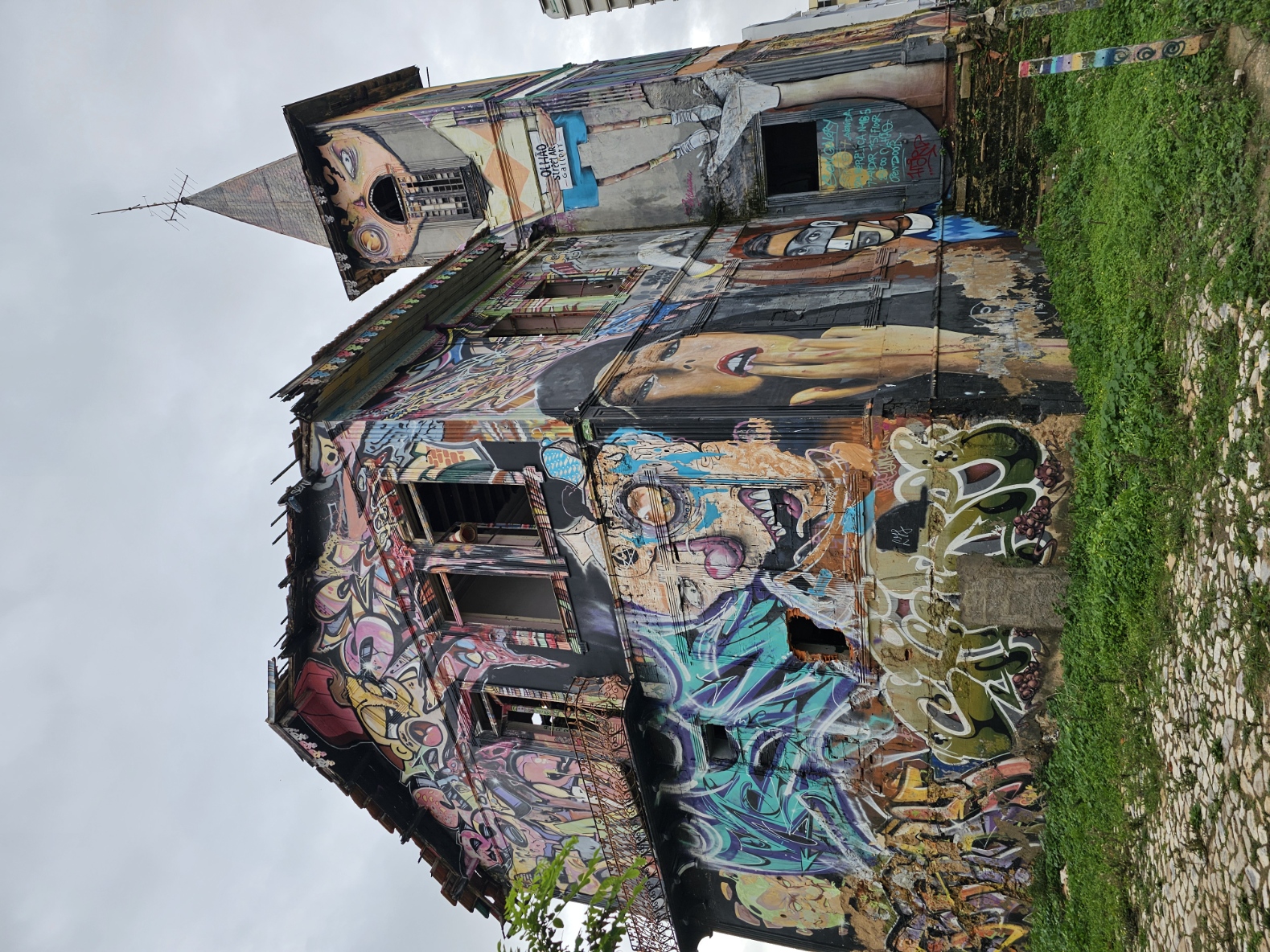 Abandoned church covered in colorful graffiti and street art murals in Olhão Portugal
