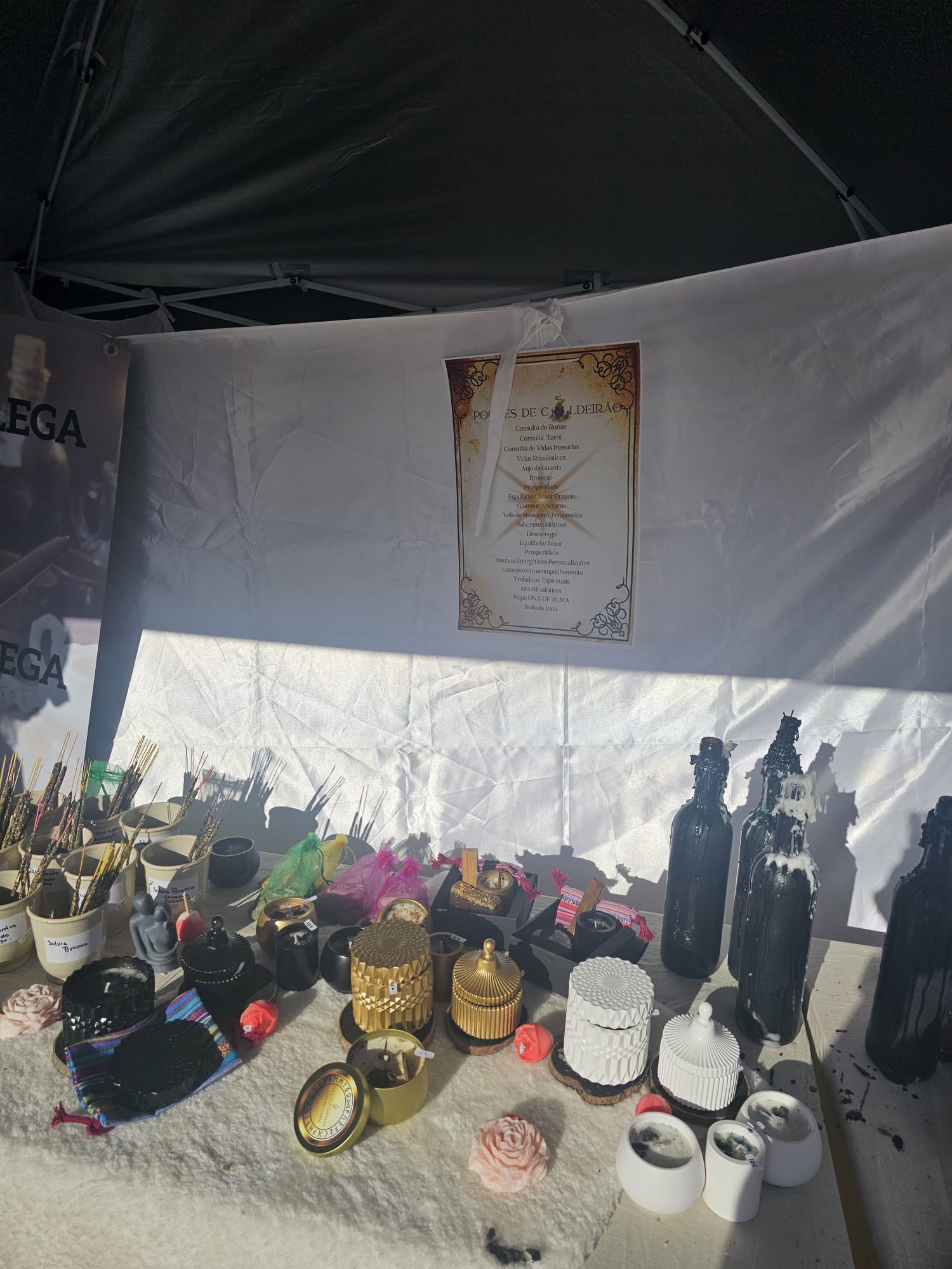 Vendor stall displaying candles, incense and mystical items at a historical festival market in Ayamonte Spain