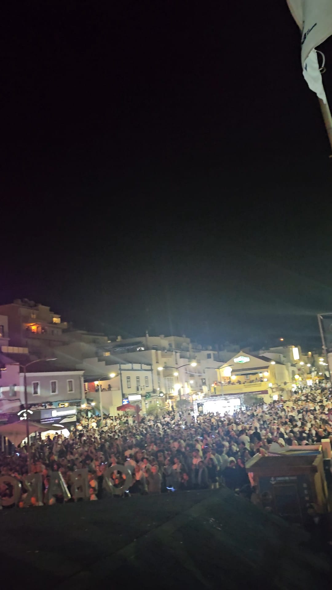 Aerial view of massive crowds filling the streets of Carvoeiro during the annual Black and White Night festival