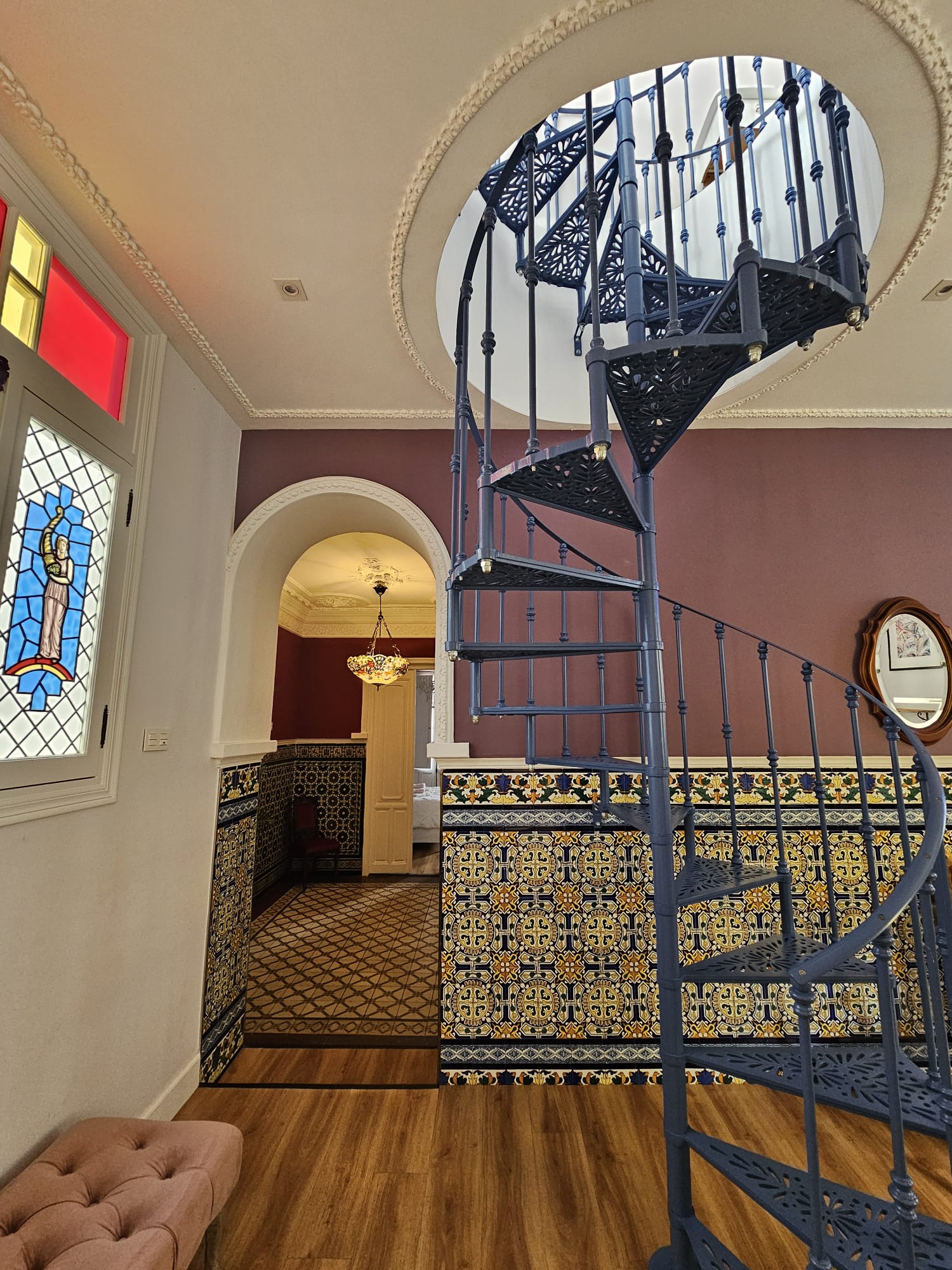 Decorative wrought iron spiral staircase inside Casa Verde apartment in Ayamonte