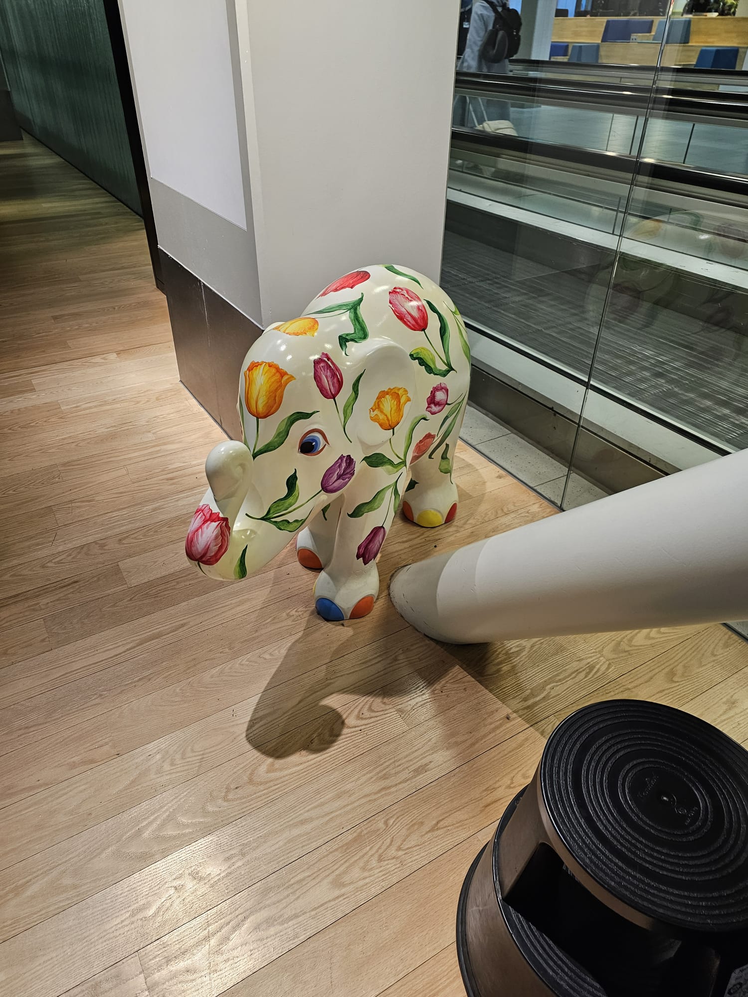 Decorative tulip-painted elephant sculpture on the floor at Amsterdam Schiphol Airport