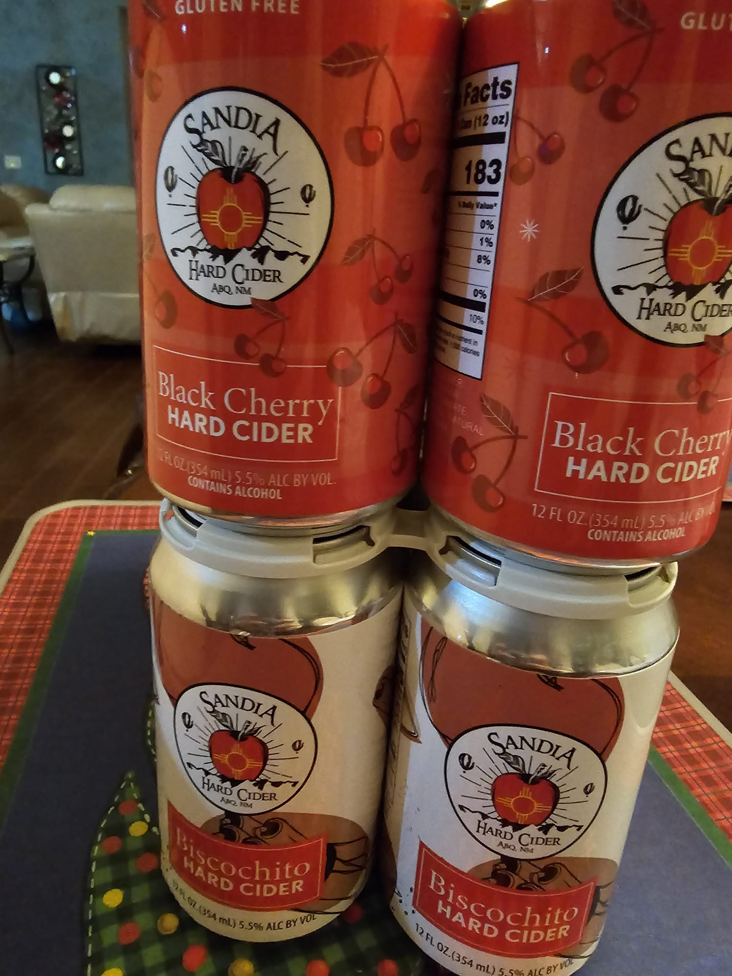 Four cans of Sandia Hard Cider from Albuquerque, New Mexico, showing Black Cherry and Biscochito gluten-free flavors