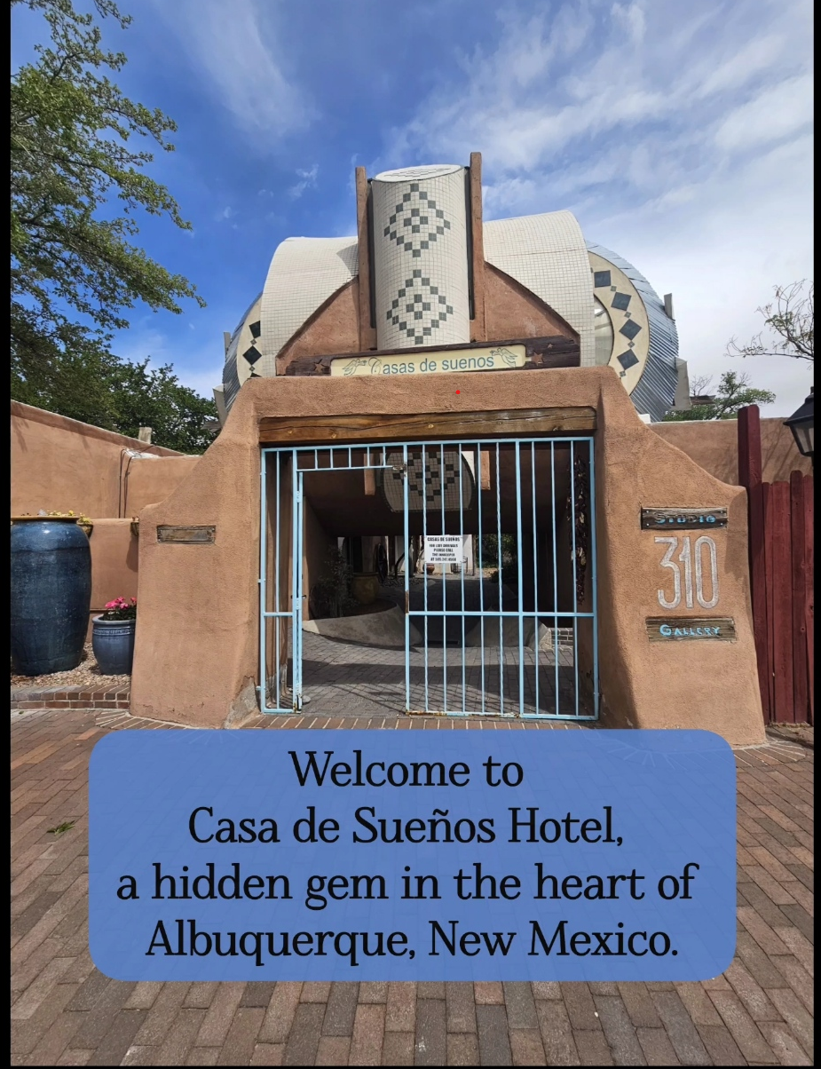 Adobe-style entrance gate to Casas de Suenos bed and breakfast in Albuquerque, New Mexico, with traditional Southwestern architecture under a blue sky
