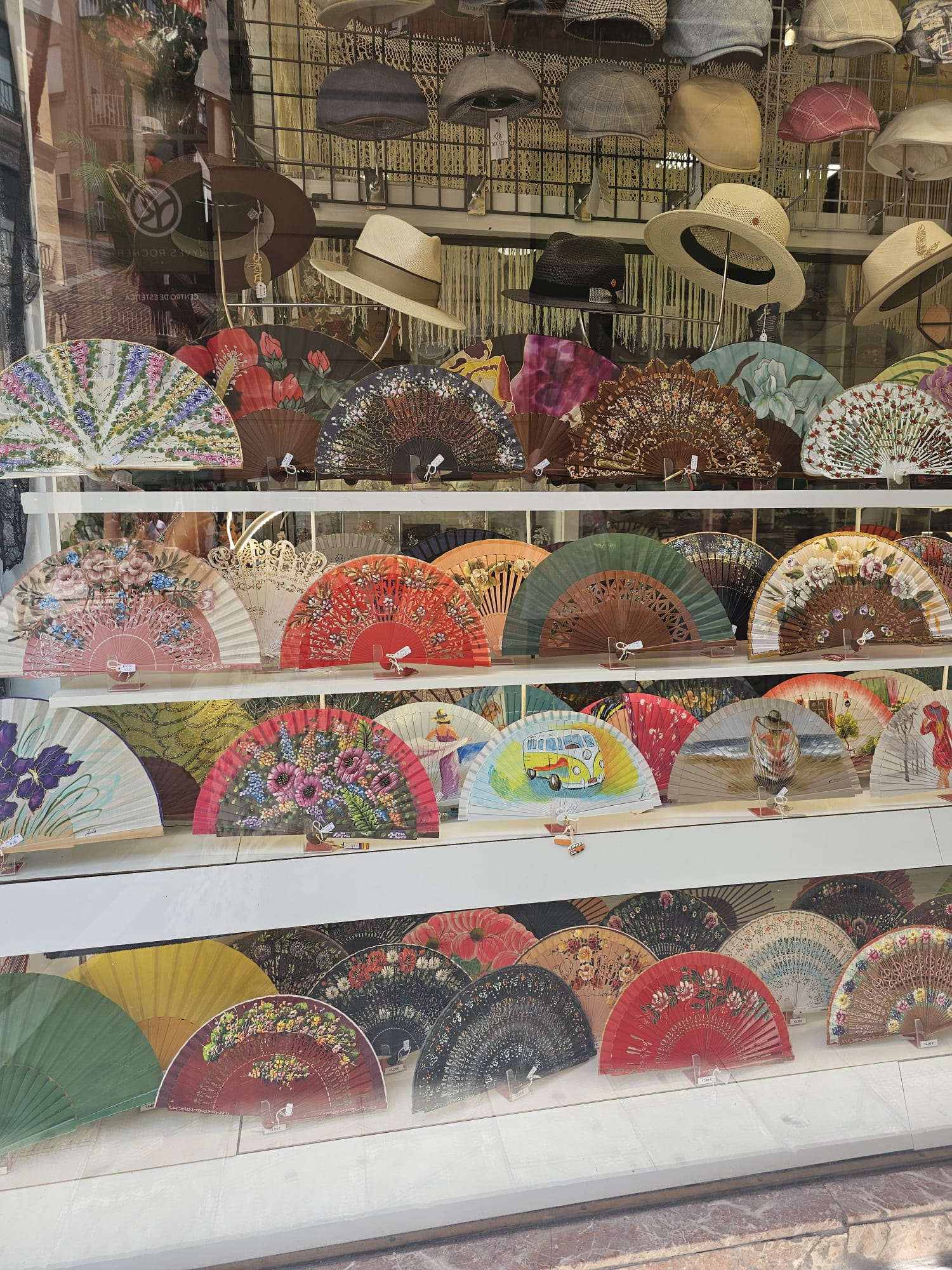 a display of colorful flamenco fans and hats.