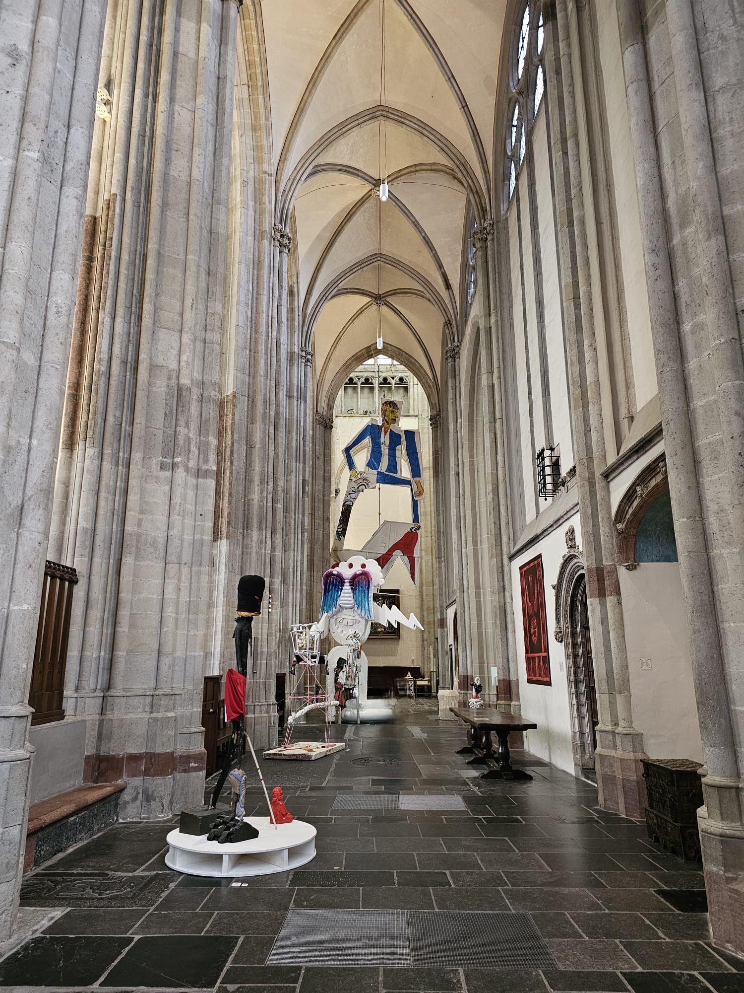Colorful contemporary art installation displayed inside the Gothic nave of Domkerk Cathedral in Utrecht