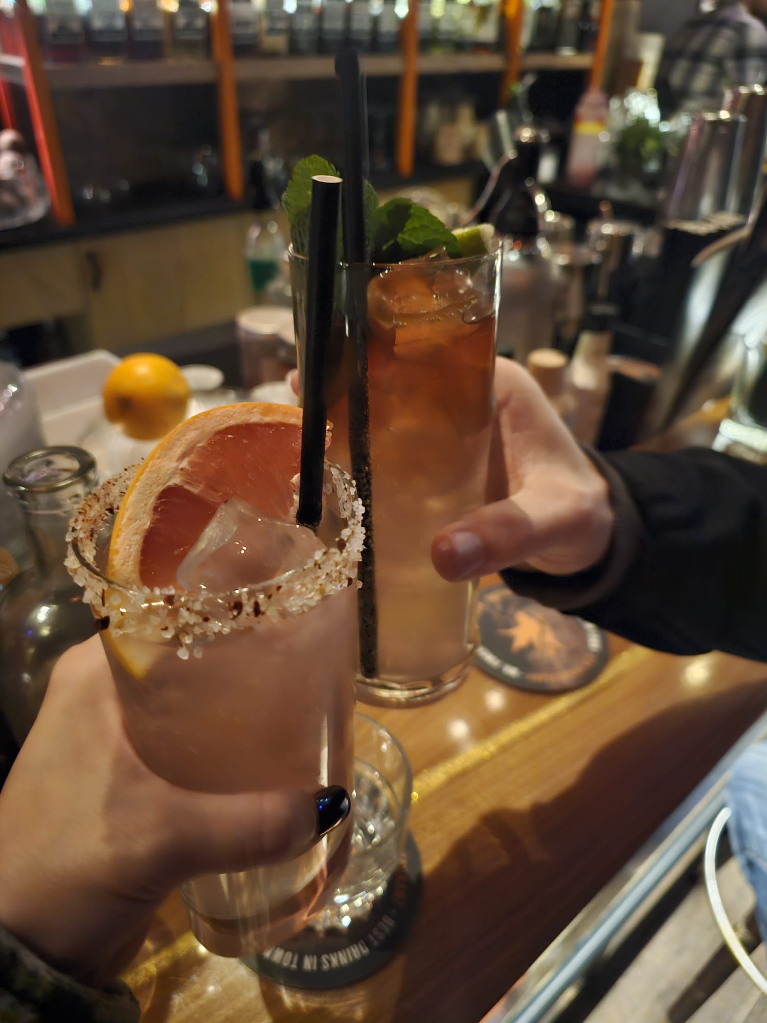 Two cocktails including a grapefruit margarita with a salted rim held up at Mr. Finch bar in Utrecht
