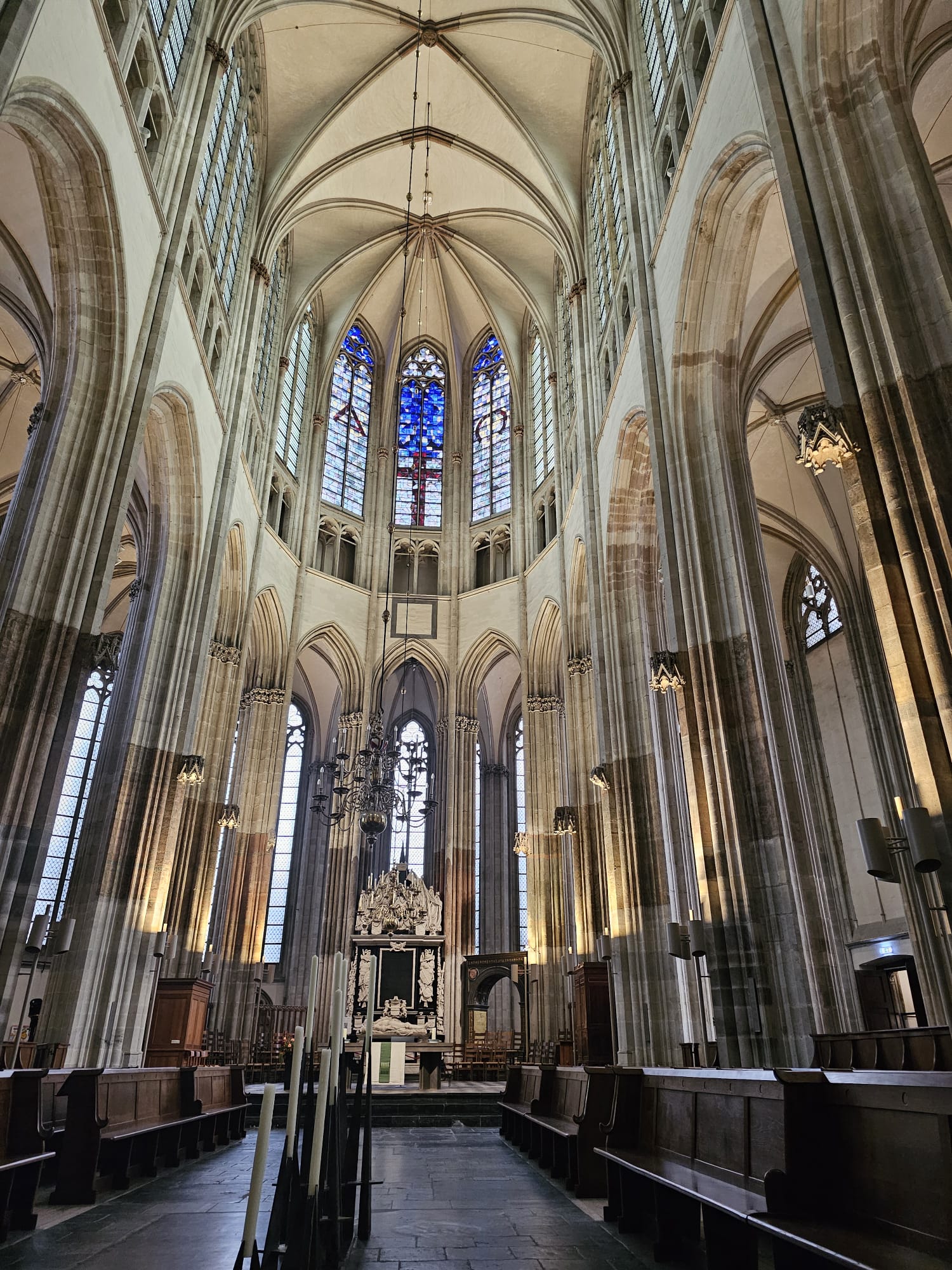 Soaring Gothic vaulted ceilings and tall stained glass windows inside Domkerk Cathedral in Utrecht, Netherlands