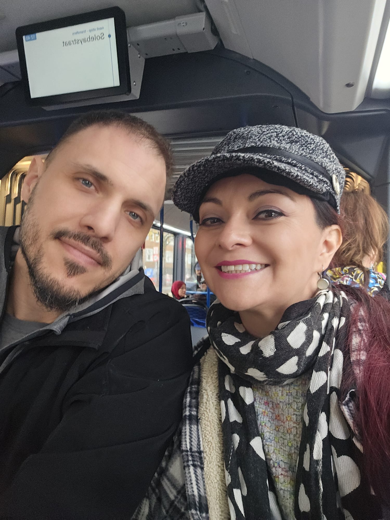 Couple smiling for a selfie on a tram in Amsterdam