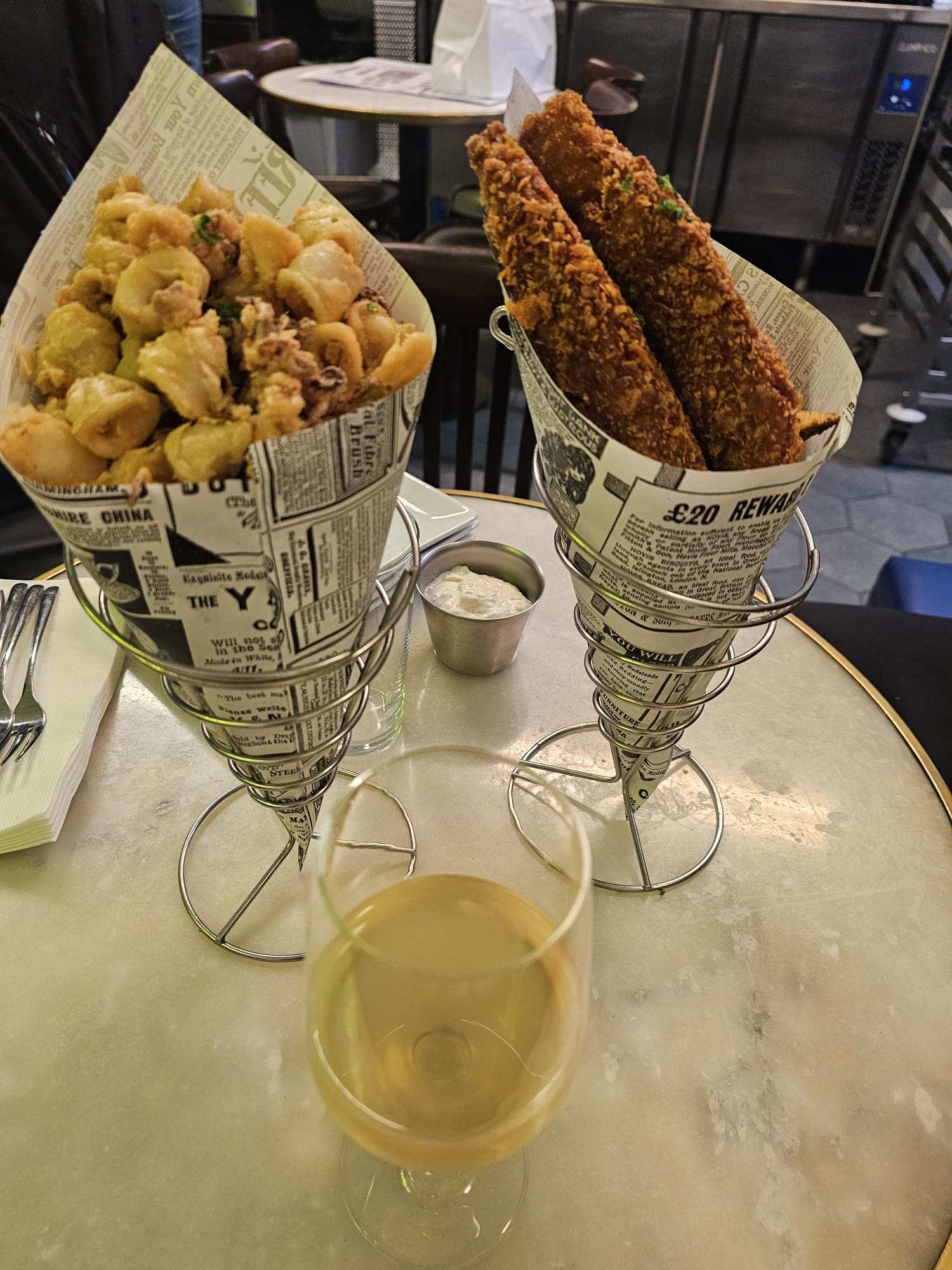 Gluten-free calamari and fish and chips served in newspaper-style cones at The Fish and Chips Shop Gluten Free in Lisbon