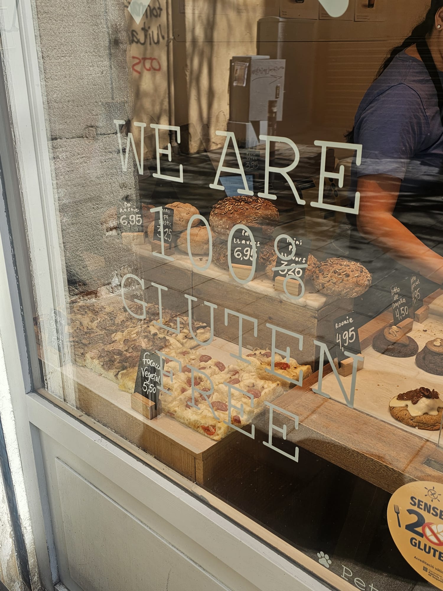 Window display of Chök the Chocolate Kitchen with "We Are 100% Gluten Free" signage and baked goods on display