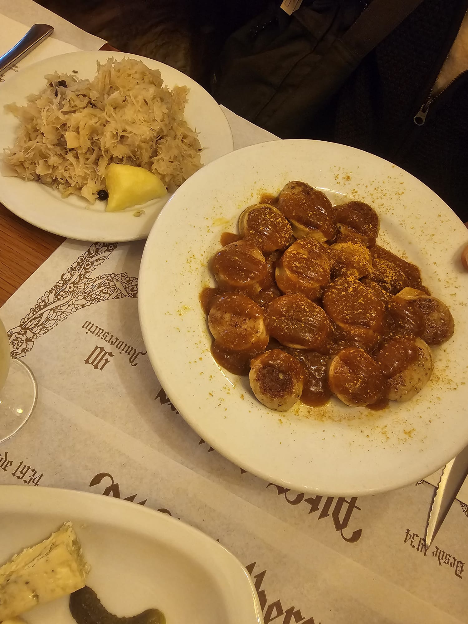 Plate of currywurst with sauerkraut and rice at Alt Heidelberg restaurant in Barcelona