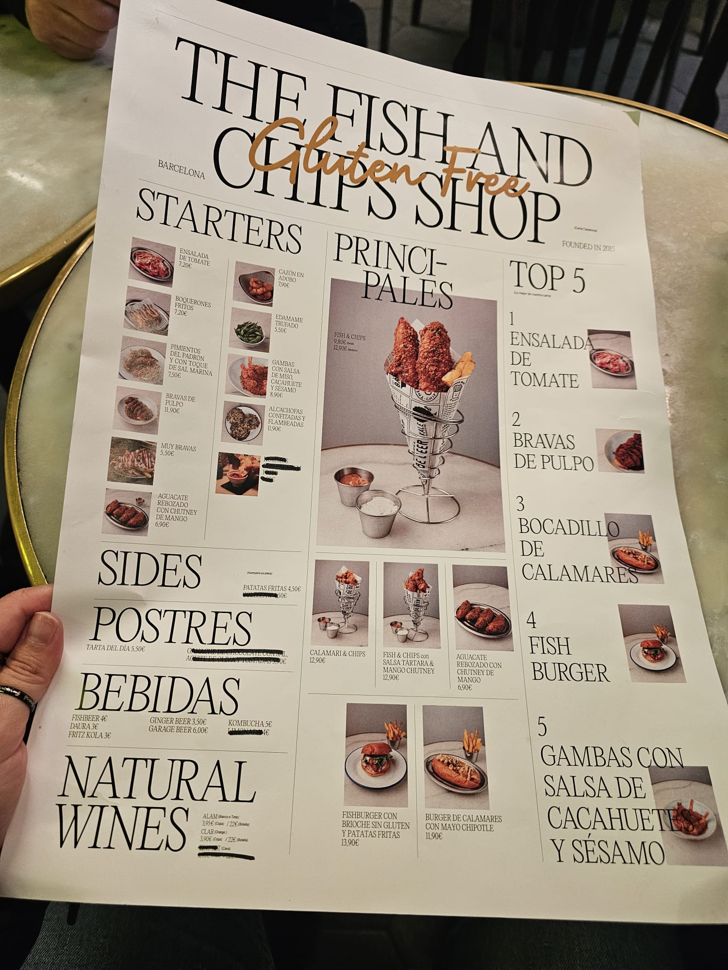 Hand holding the menu for The Fish and Chips Shop Gluten Free restaurant in Lisbon, Portugal